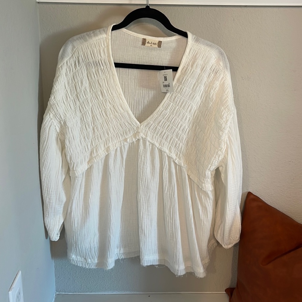 A loose and flowing white top - perfect for a casual night out with denim.